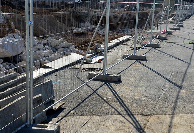 an orange temporary fence panel used to block off an area on a construction site